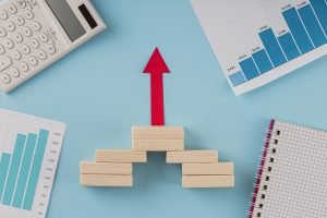 - top view business items with growth chart arrow